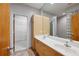 Bathroom featuring double sinks, bright cabinets, and doorway leading to closet at 1294 Fernwood Ne Cir, Brookhaven, GA 30319