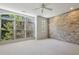 Spacious bedroom with large windows offering views of greenery and exposed brick accent wall at 1294 Fernwood Ne Cir, Brookhaven, GA 30319