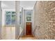 Welcoming entryway features brick wall, wood door, hardwood floors, and staircase leading up to living area at 1294 Fernwood Ne Cir, Brookhaven, GA 30319