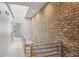 Upstairs hallway with exposed brick wall, modern railing, access to rooms, and a skylight at 1294 Fernwood Ne Cir, Brookhaven, GA 30319