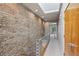 Upstairs hallway featuring a modern railing, skylight, brick wall and access to other rooms at 1294 Fernwood Ne Cir, Brookhaven, GA 30319