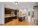 Well-appointed kitchen with stainless steel appliances, dark cabinets, an island, and hardwood floors at 1294 Fernwood Ne Cir, Brookhaven, GA 30319