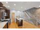 Open concept kitchen featuring stainless appliances, hardwood floors, and exposed brick staircase at 1294 Fernwood Ne Cir, Brookhaven, GA 30319