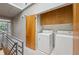 Hallway view of laundry room with bright cabinets and modern washer and dryer at 1294 Fernwood Ne Cir, Brookhaven, GA 30319