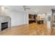 Open concept living room featuring fireplace, hardwood floors, stainless steel appliances, and exposed staircase at 1294 Fernwood Ne Cir, Brookhaven, GA 30319