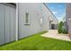 Backyard featuring artificial grass, a stone walkway, and gray siding on the house at 135 Channing Ln, Fayetteville, GA 30214