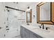 Modern bathroom featuring a double vanity, marble tiled shower with glass door and black hardware at 135 Channing Ln, Fayetteville, GA 30214