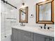 Stylish bathroom with double vanity, quartz countertop, and glass enclosed shower at 135 Channing Ln, Fayetteville, GA 30214
