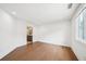 Spacious bedroom featuring hardwood floors, white walls, and a window with natural light at 135 Channing Ln, Fayetteville, GA 30214