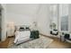 Bedroom featuring a bed, a high ceiling with tall windows at 135 Channing Ln, Fayetteville, GA 30214