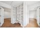 Hallway with custom built-in white shelving and hardwood floors leading to other rooms at 135 Channing Ln, Fayetteville, GA 30214