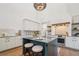 Modern kitchen with island seating, a stainless steel oven, and a stylish tile backsplash at 135 Channing Ln, Fayetteville, GA 30214