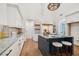 Bright, modern kitchen featuring granite countertops, white cabinets, and a large island with seating at 135 Channing Ln, Fayetteville, GA 30214
