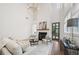Bright living room with fireplace, hardwood floors, and soaring ceilings with decorative lighting fixture at 135 Channing Ln, Fayetteville, GA 30214