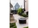 Charming patio with outdoor seating, fire pit, and manicured landscaping at 135 Channing Ln, Fayetteville, GA 30214