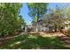 Scenic backyard view, showcasing the home's architecture and ample green space at 220 Autumn Sage Dr, Alpharetta, GA 30005