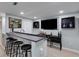 Basement wet bar with counter seating, cabinets, and decor at 220 Autumn Sage Dr, Alpharetta, GA 30005