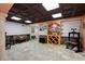 Finished basement with tile floor, wine rack, and wooden furniture at 220 Autumn Sage Dr, Alpharetta, GA 30005