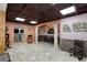 Finished basement with tile floor, columns, and archways at 220 Autumn Sage Dr, Alpharetta, GA 30005
