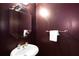 Bathroom featuring an octagon mirror, white sink, and dark paint at 220 Autumn Sage Dr, Alpharetta, GA 30005