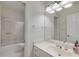 Bright bathroom featuring a shower-tub combination, vanity, and stylish decor at 220 Autumn Sage Dr, Alpharetta, GA 30005