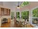 Bright breakfast nook with a large table, windows with views of the trees, and a desk area at 220 Autumn Sage Dr, Alpharetta, GA 30005