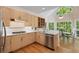Bright eat-in kitchen featuring granite countertops, stainless steel appliances and hardwood flooring at 220 Autumn Sage Dr, Alpharetta, GA 30005