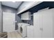 Laundry room with washer, dryer, storage cabinets, and sink at 220 Autumn Sage Dr, Alpharetta, GA 30005