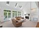 Bright living room with skylights, fireplace, and French doors leading to outdoor area at 220 Autumn Sage Dr, Alpharetta, GA 30005