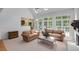 Airy living room featuring a fireplace, tall windows, and comfortable seating at 220 Autumn Sage Dr, Alpharetta, GA 30005