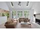 Spacious living room featuring a fireplace, tall windows, and comfortable seating at 220 Autumn Sage Dr, Alpharetta, GA 30005
