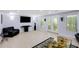 Bright living room showcasing access to the deck, complemented by modern lighting fixtures at 220 Autumn Sage Dr, Alpharetta, GA 30005