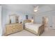 Relaxing main bedroom featuring a decorative fireplace, tray ceilings, and furniture at 220 Autumn Sage Dr, Alpharetta, GA 30005