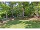A lush, expansive backyard with established trees, garden beds, and room for outdoor enjoyment at 3051 Deanna Way, Lawrenceville, GA 30044