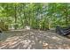 The backyard features a basketball court and a wooded area at 3051 Deanna Way, Lawrenceville, GA 30044