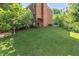 Large backyard with a well-maintained lawn and mature landscaping, bordering the house at 3051 Deanna Way, Lawrenceville, GA 30044