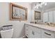 Bathroom with a granite countertop, modern fixtures, and decorative mirror at 3051 Deanna Way, Lawrenceville, GA 30044