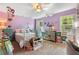 Charming bedroom with colorful decor, bright windows, and ceiling fan at 3051 Deanna Way, Lawrenceville, GA 30044