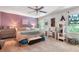 Bright bedroom features natural light, ceiling fan, and eclectic furnishings at 3051 Deanna Way, Lawrenceville, GA 30044
