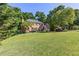 Well-maintained brick house on a large, grassy lot with mature trees at 3051 Deanna Way, Lawrenceville, GA 30044