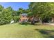 Beautiful brick home with a lush green lawn and mature trees at 3051 Deanna Way, Lawrenceville, GA 30044