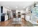 Spacious kitchen featuring white cabinetry, stainless steel appliances, granite counters, and breakfast bar at 3051 Deanna Way, Lawrenceville, GA 30044