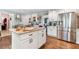 Spacious kitchen featuring white cabinetry, stainless steel appliances, granite counters, and island at 3051 Deanna Way, Lawrenceville, GA 30044