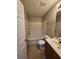 Bathroom features a tub, white tile, a vanity with wood colored drawers and tile floors at 3336 Waldrop Trl, Decatur, GA 30034