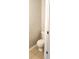 Clean half bathroom featuring white toilet and neutral walls, providing a functional space for residents and guests at 3336 Waldrop Trl, Decatur, GA 30034