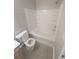 Bathroom showing the white shower-tub combo, toilet, and tile floor with vanity peeking in at 3336 Waldrop Trl, Decatur, GA 30034