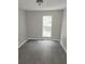 Cozy bedroom featuring fresh neutral paint, hardwood floors, and a window for ample light at 3336 Waldrop Trl, Decatur, GA 30034