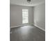 A bedroom with a light, walls painted gray, and a large window for natural light at 3336 Waldrop Trl, Decatur, GA 30034