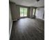 Comfortable bedroom featuring two windows, neutral walls, and modern flooring at 3336 Waldrop Trl, Decatur, GA 30034
