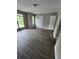 Bright bedroom featuring modern floors, neutral walls, two windows, and two doors at 3336 Waldrop Trl, Decatur, GA 30034